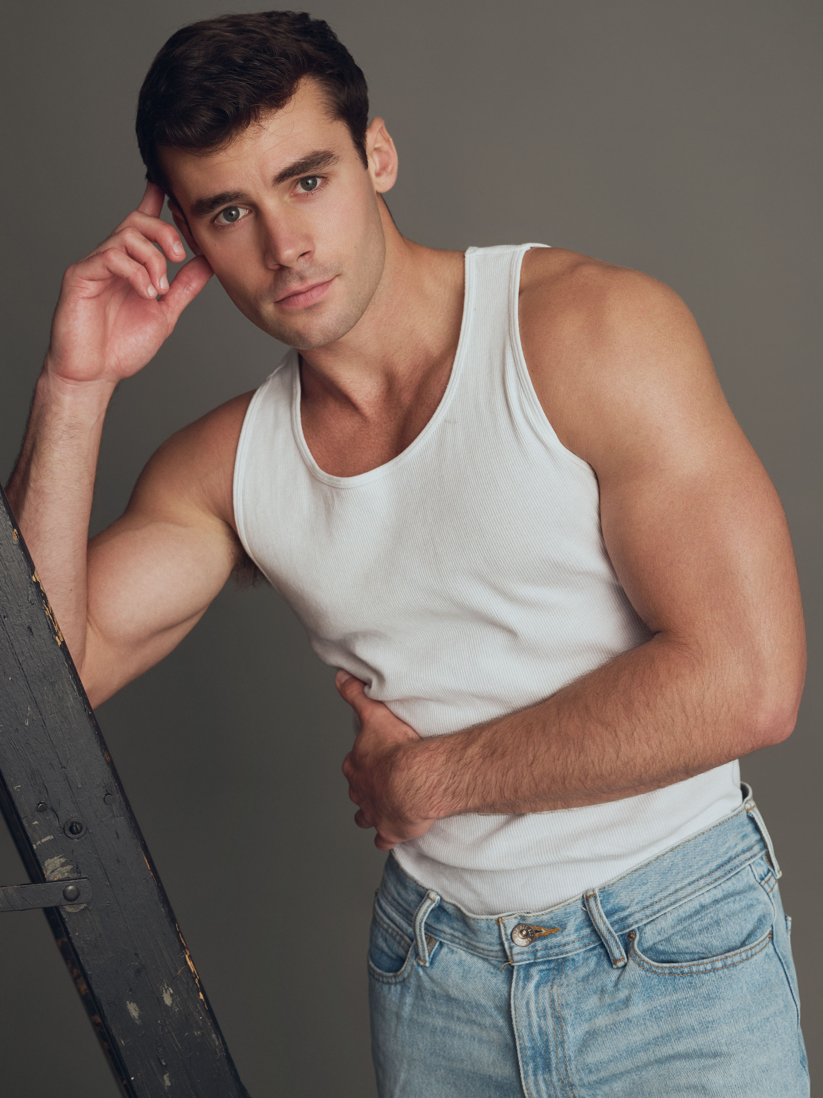 Jake_15_WEB Male model Jake wearing a white tank top and jeans, photographed in studio during a professional portfolio shoot