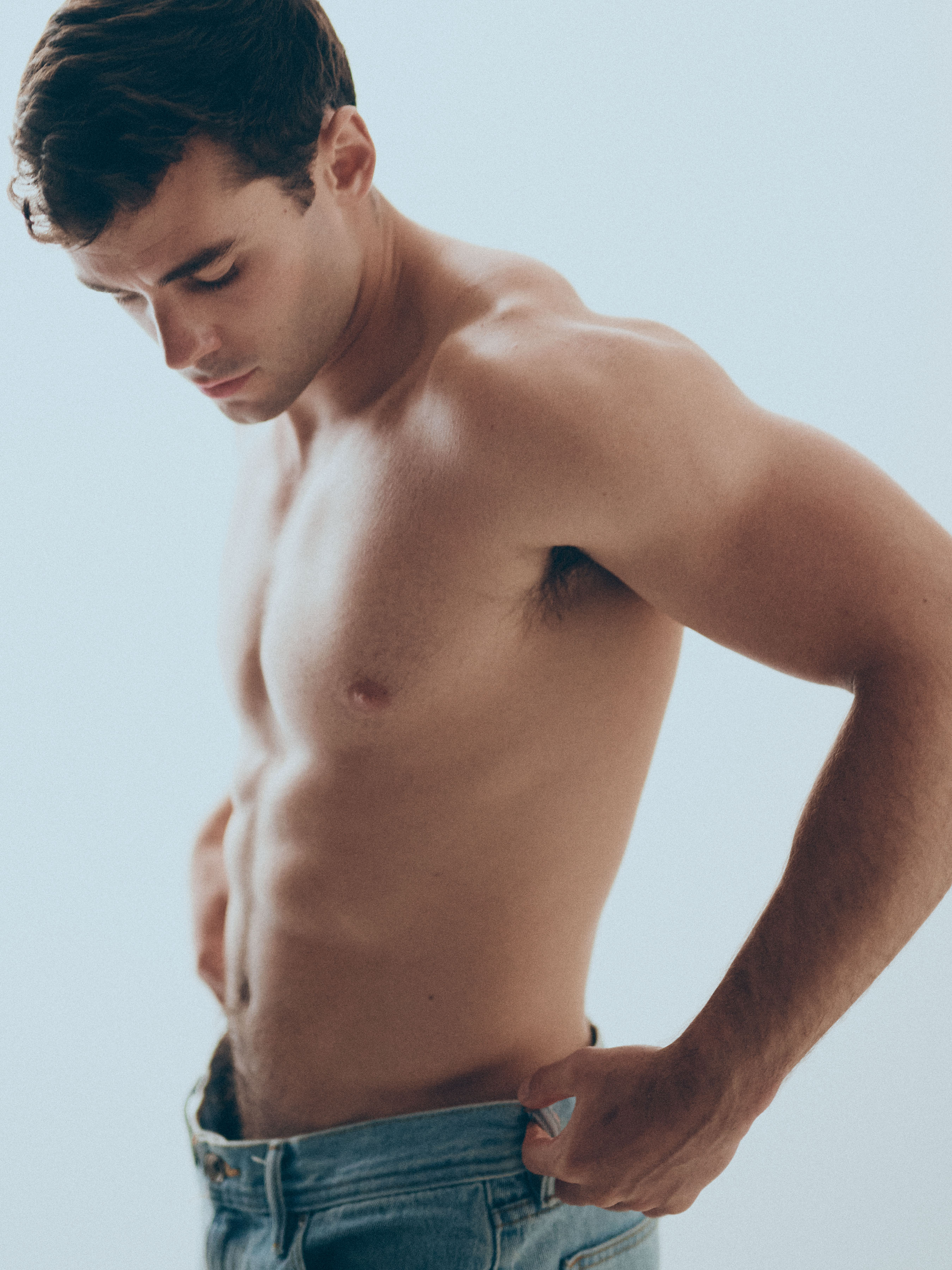 Jake_23_WEB Shirtless male model Jake photographed in studio wearing jeans, shown in side profile during a professional portfolio shoot