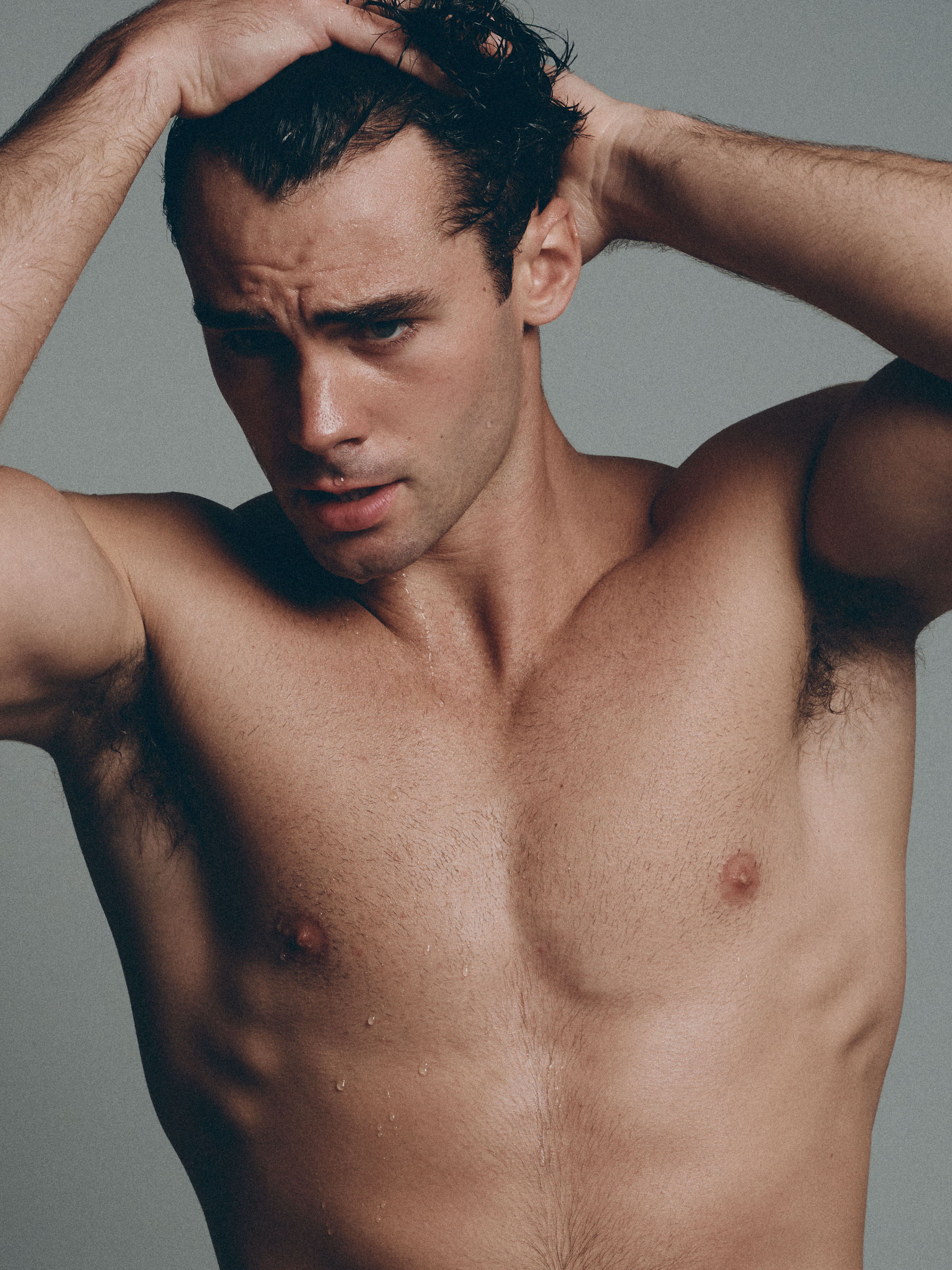 Jake_25_WEB Shirtless male model Jake photographed in studio with water and dramatic lighting during a professional portfolio shoot