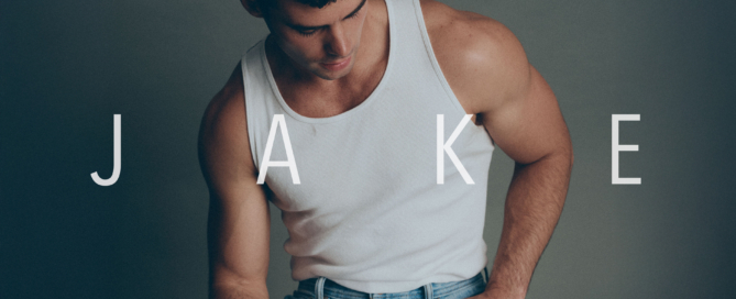 Male model Jake wearing a white tank top and jeans during a professional portfolio photoshoot
